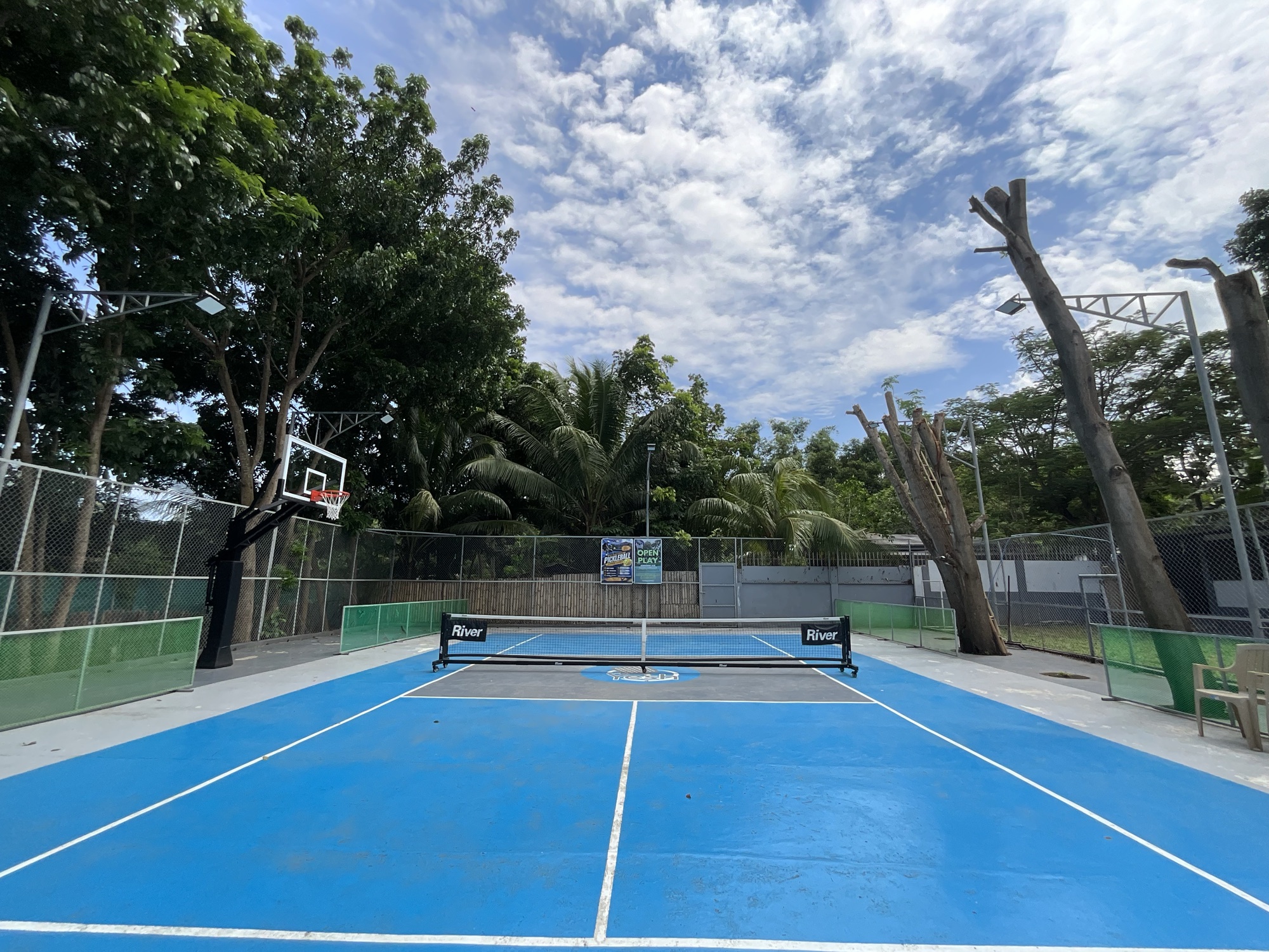 The basketball half court, with the single ring at the far end