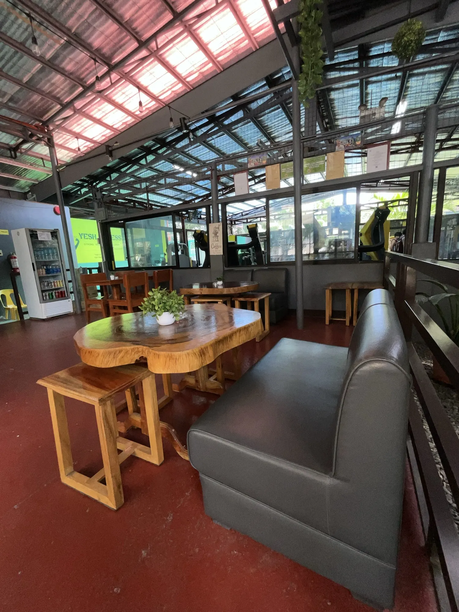 Long live-edge wooden table and a leather bench inside Ka PaPio's Cafe