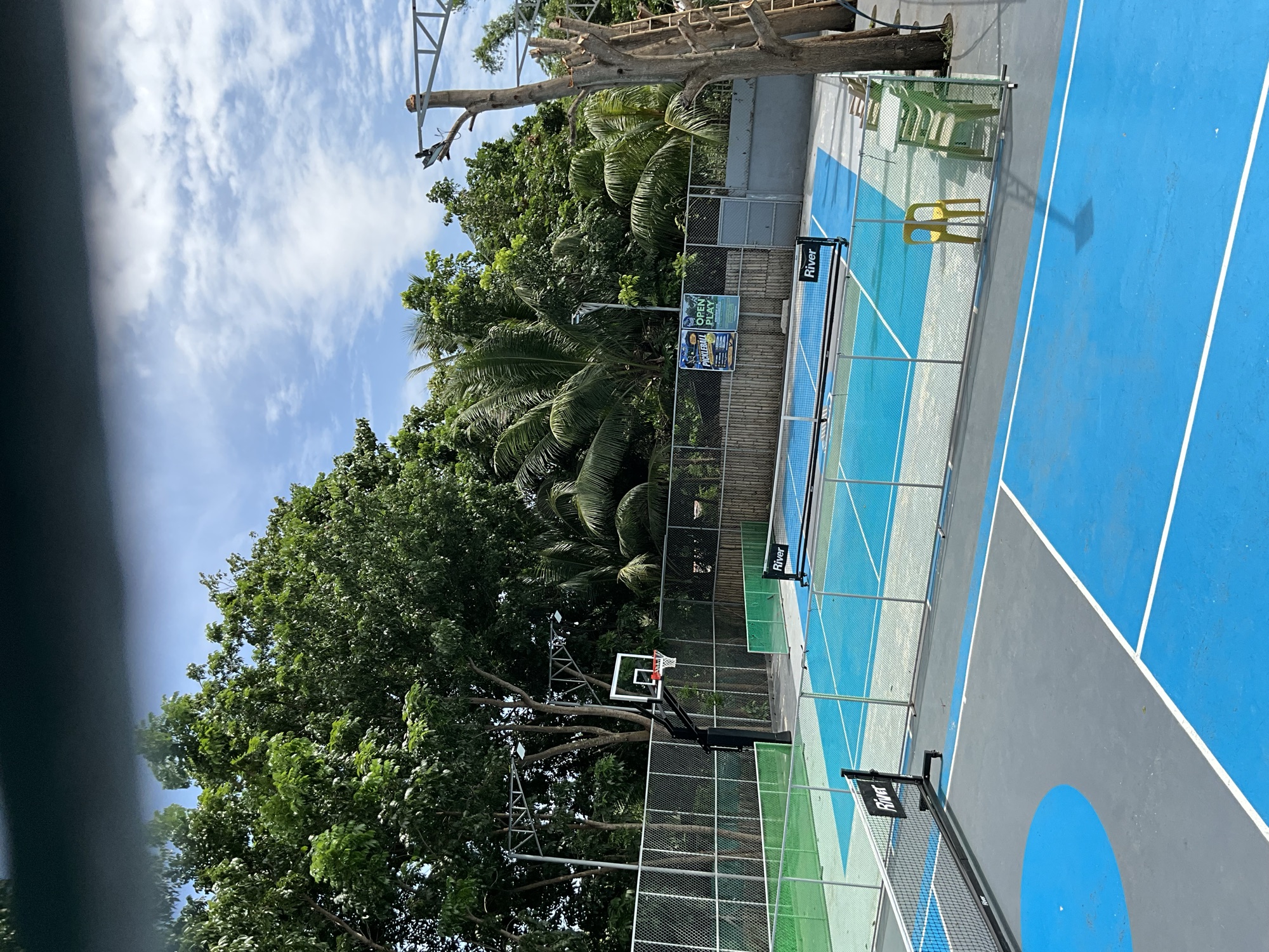 Both courts seen together, blue and green surfaces side by side