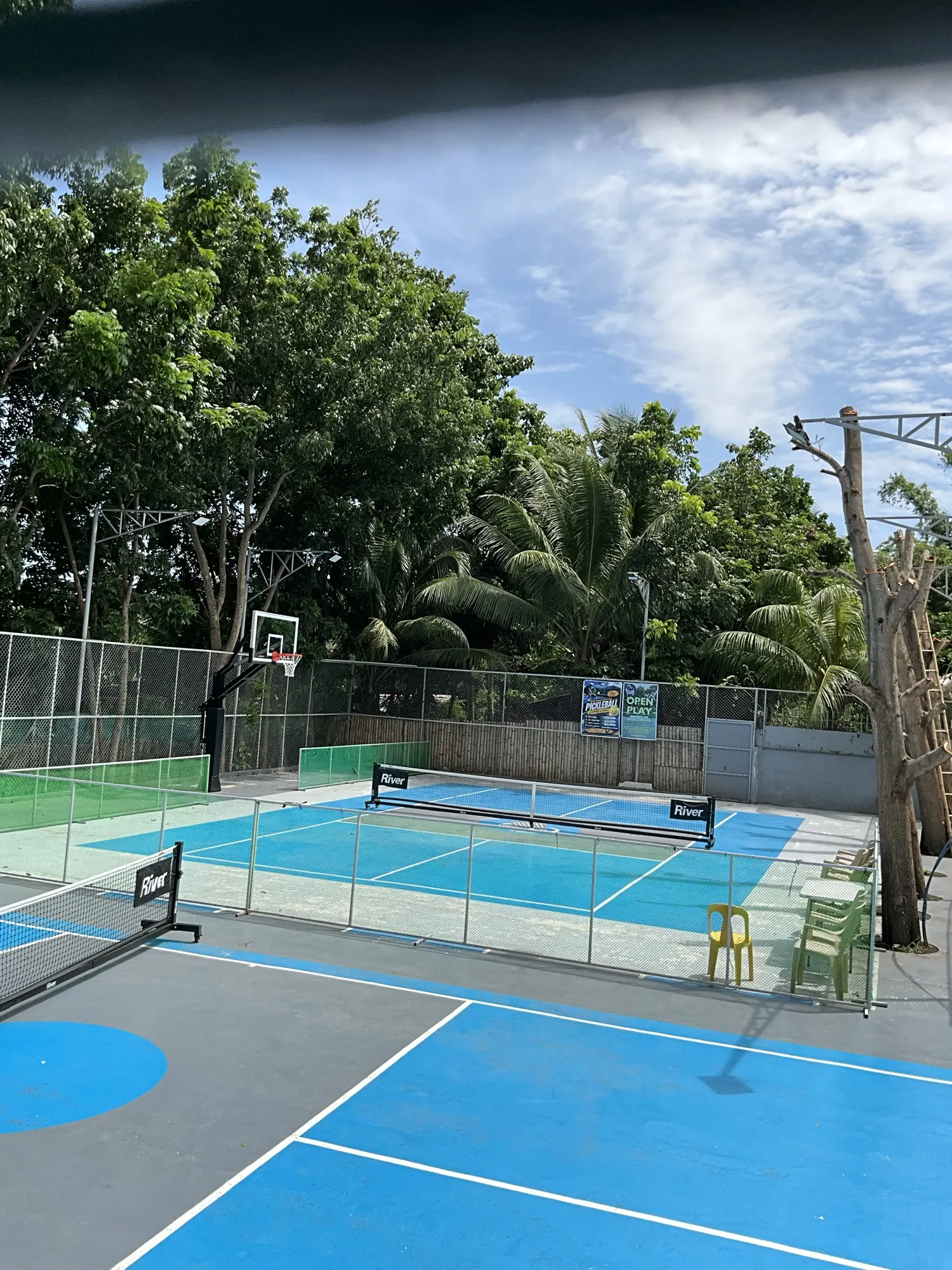 Both courts seen together, blue and green surfaces side by side
