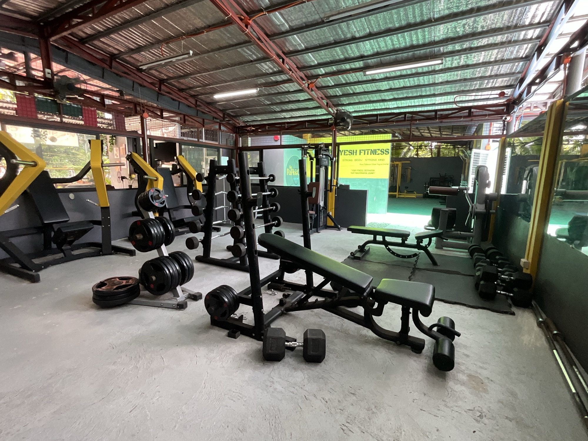 Squat racks, benches and dumbbells on the weight floor