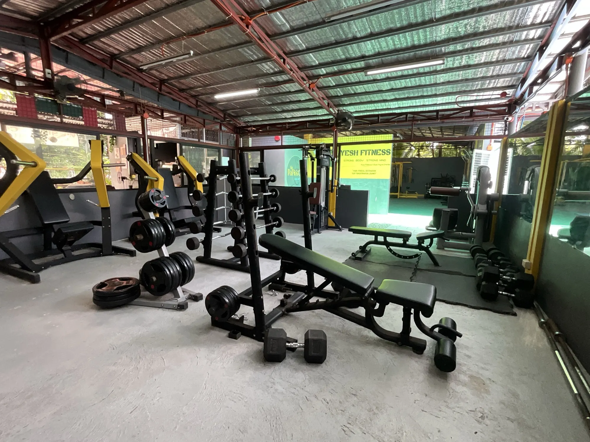 Squat racks, benches and dumbbells on the weight floor