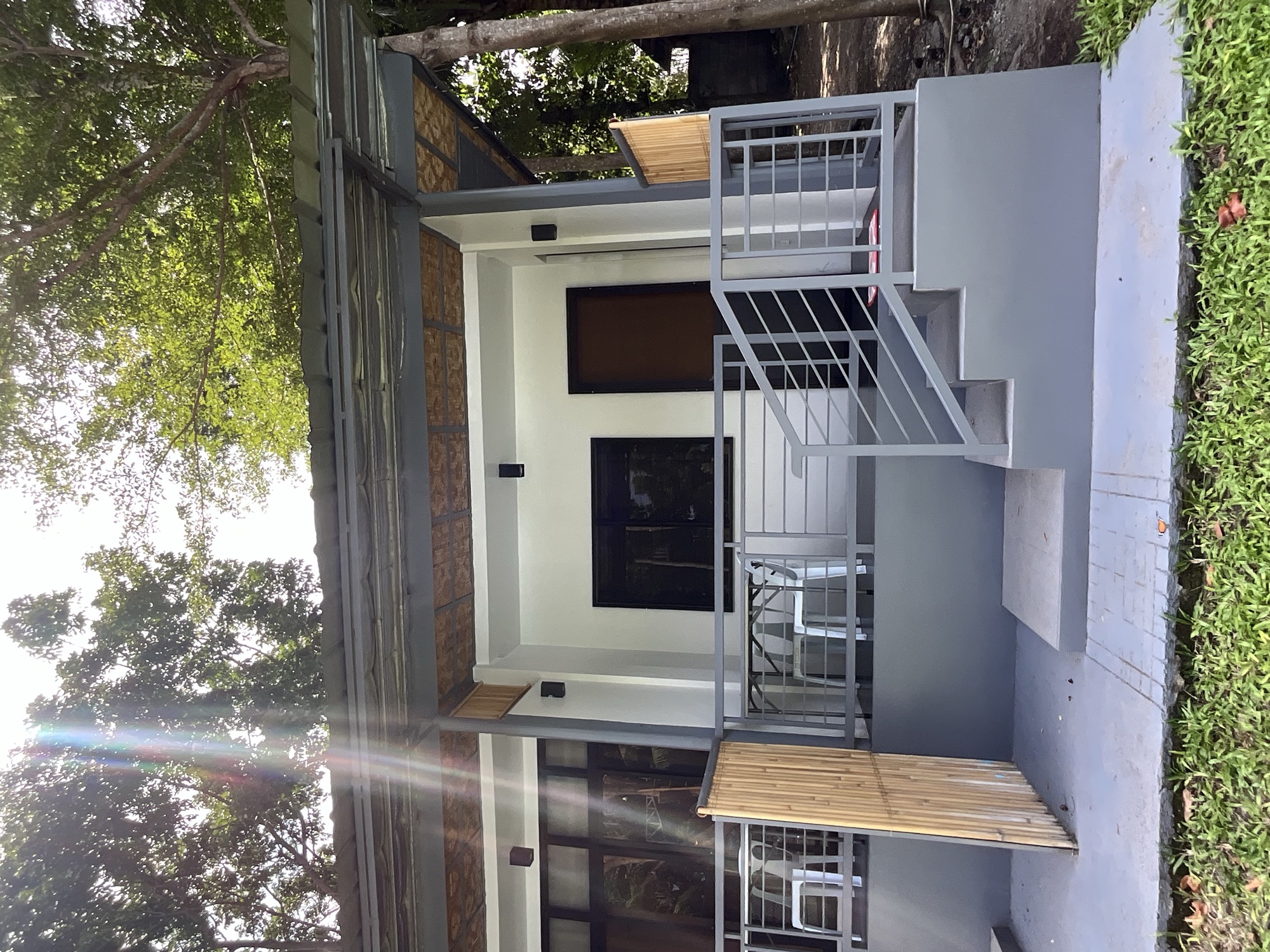 Covered porch and steps outside one of the rooms at PaPio's Nest