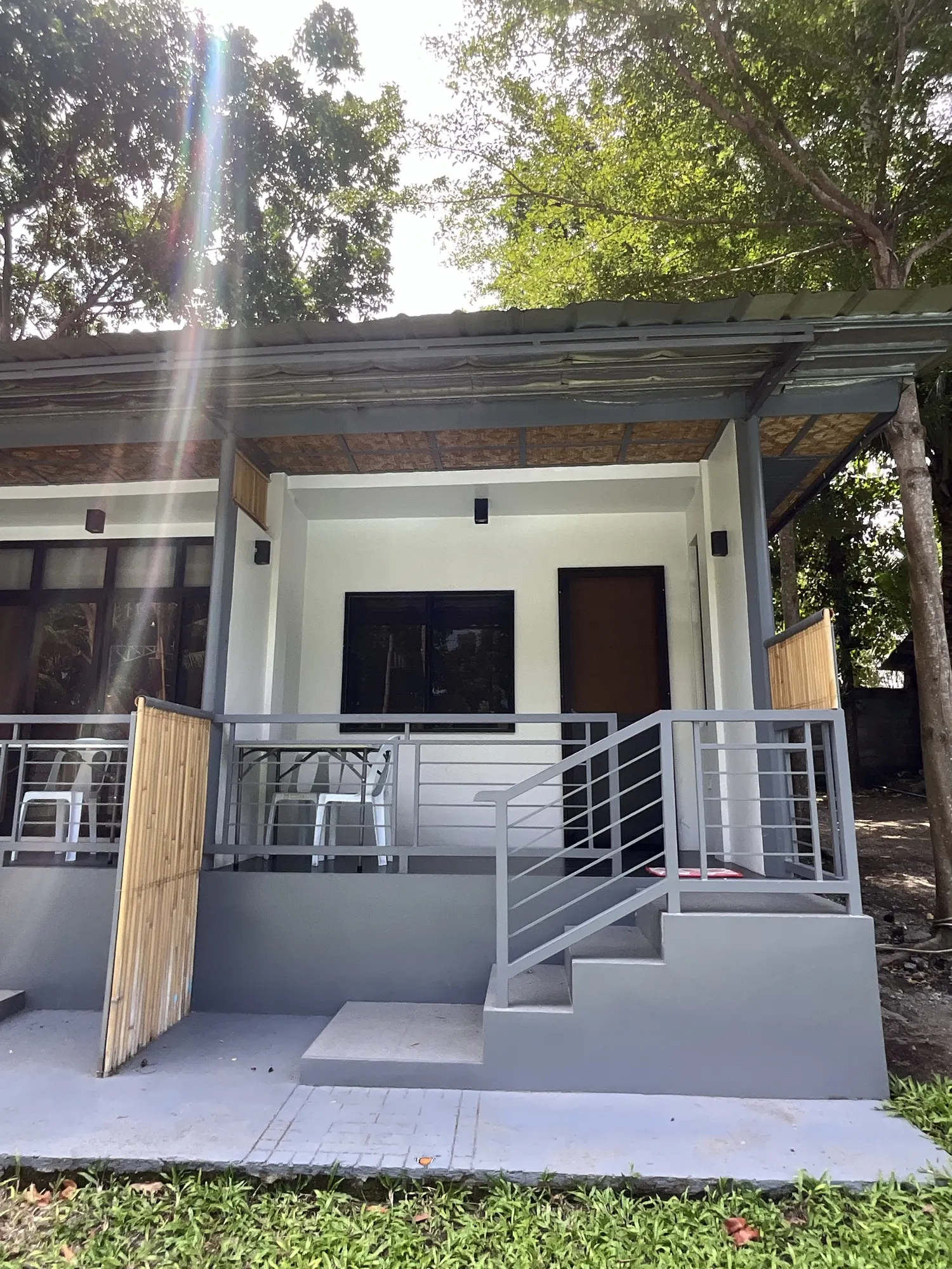 Covered porch and steps outside one of the rooms at PaPio's Nest