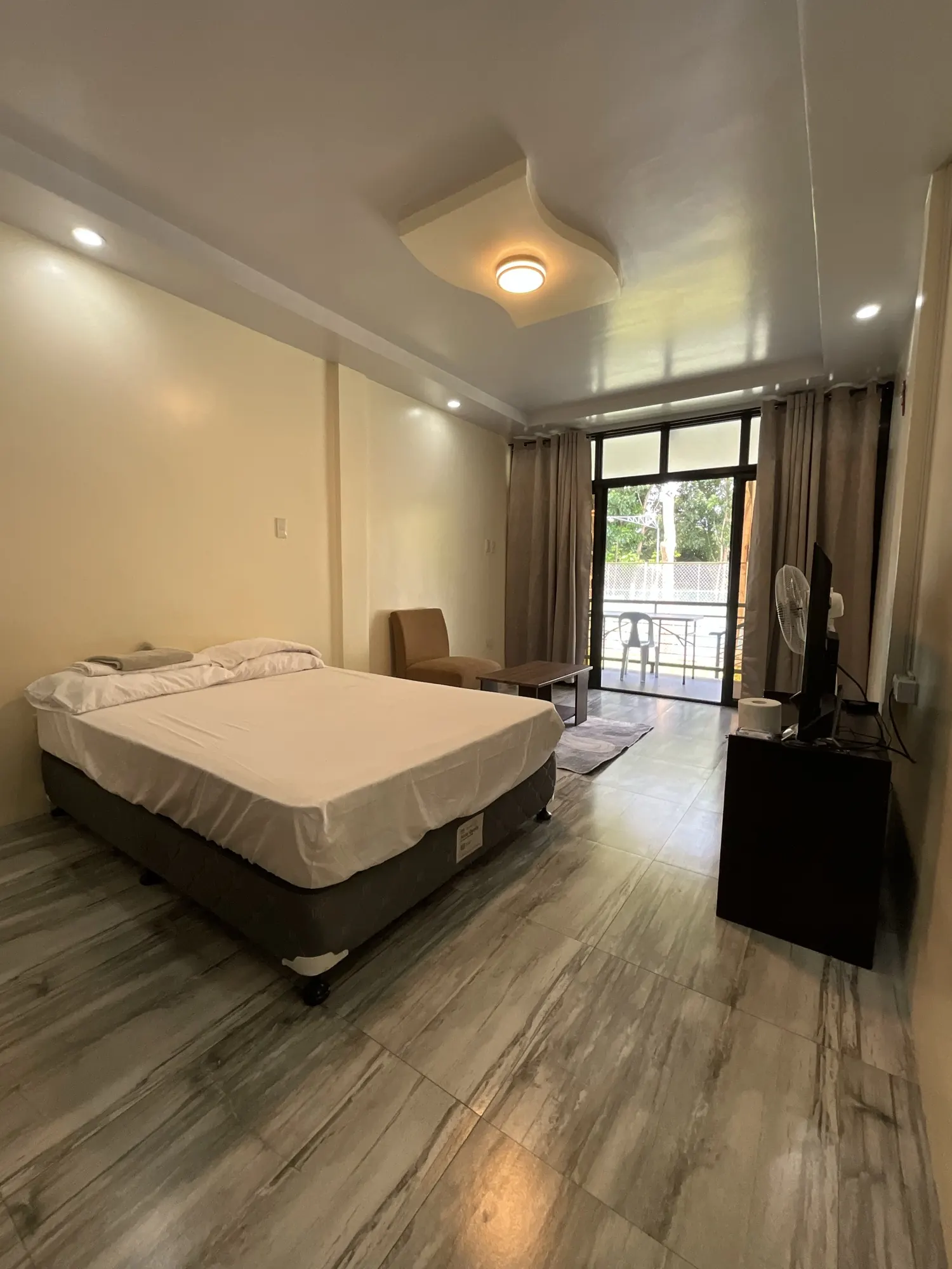 Bright room with a bed and a glass door opening to a balcony