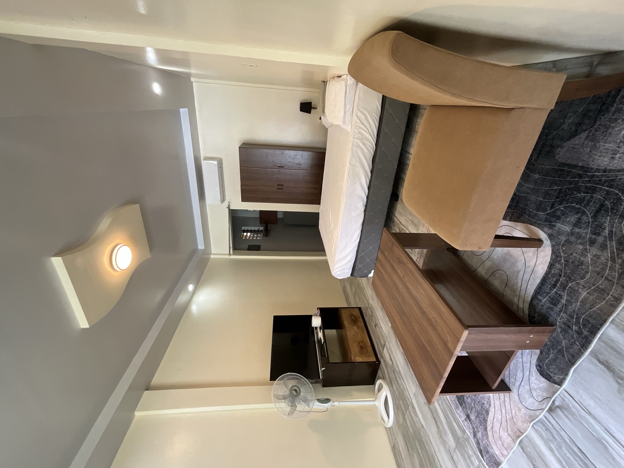Room with the split-type air conditioner, television and wardrobe