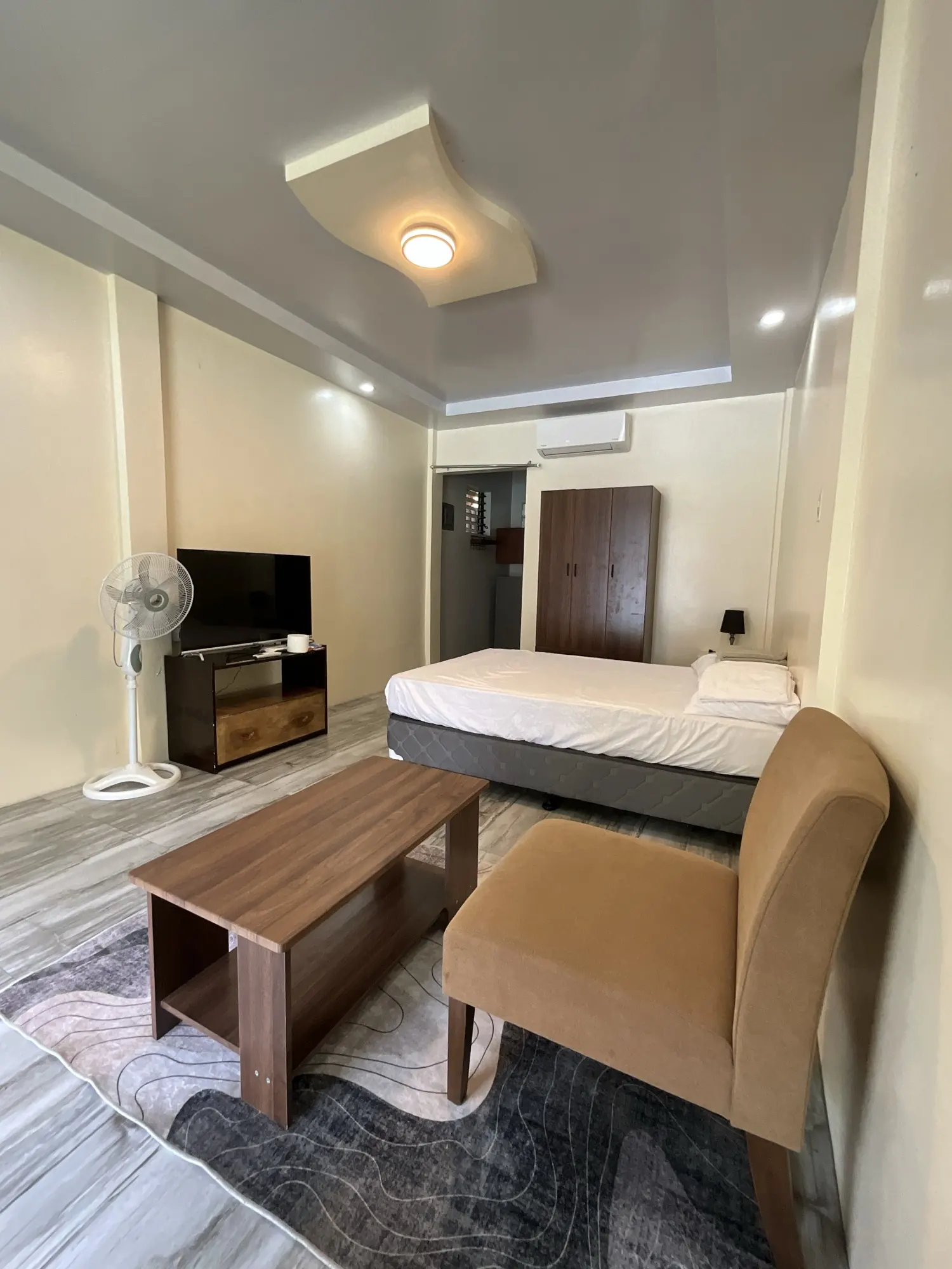 Room with the split-type air conditioner, television and wardrobe